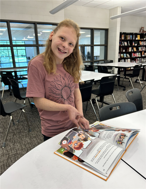 Image of a girl reading book in library